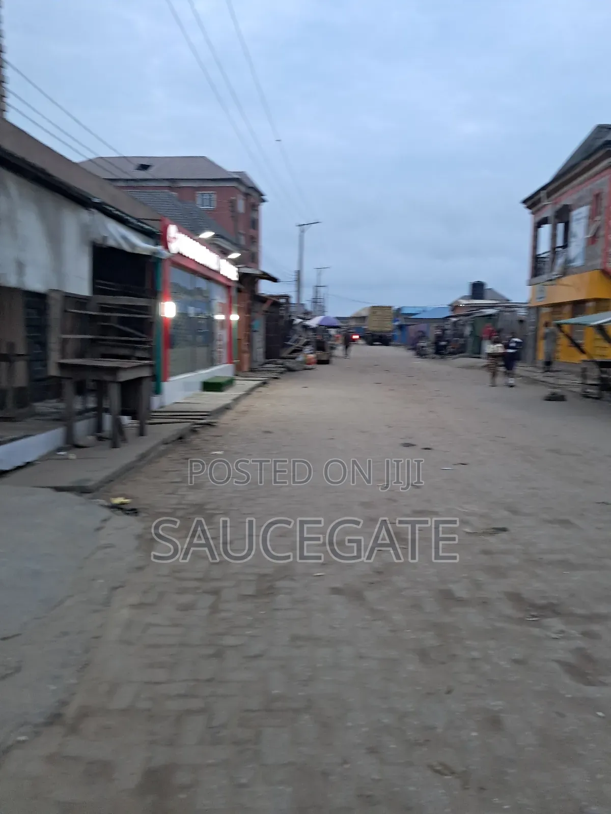 Land Facing a Busy Food Markert at Ijegun in Satellite Town
