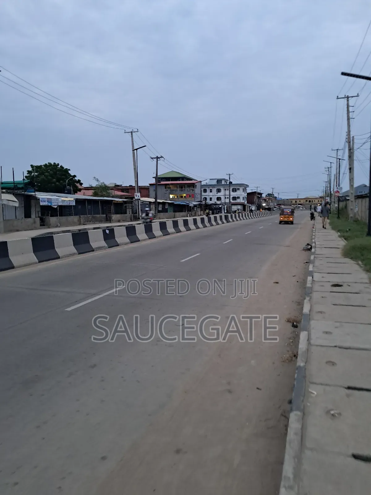 Land Facing a Busy Food Markert at Ijegun in Satellite Town