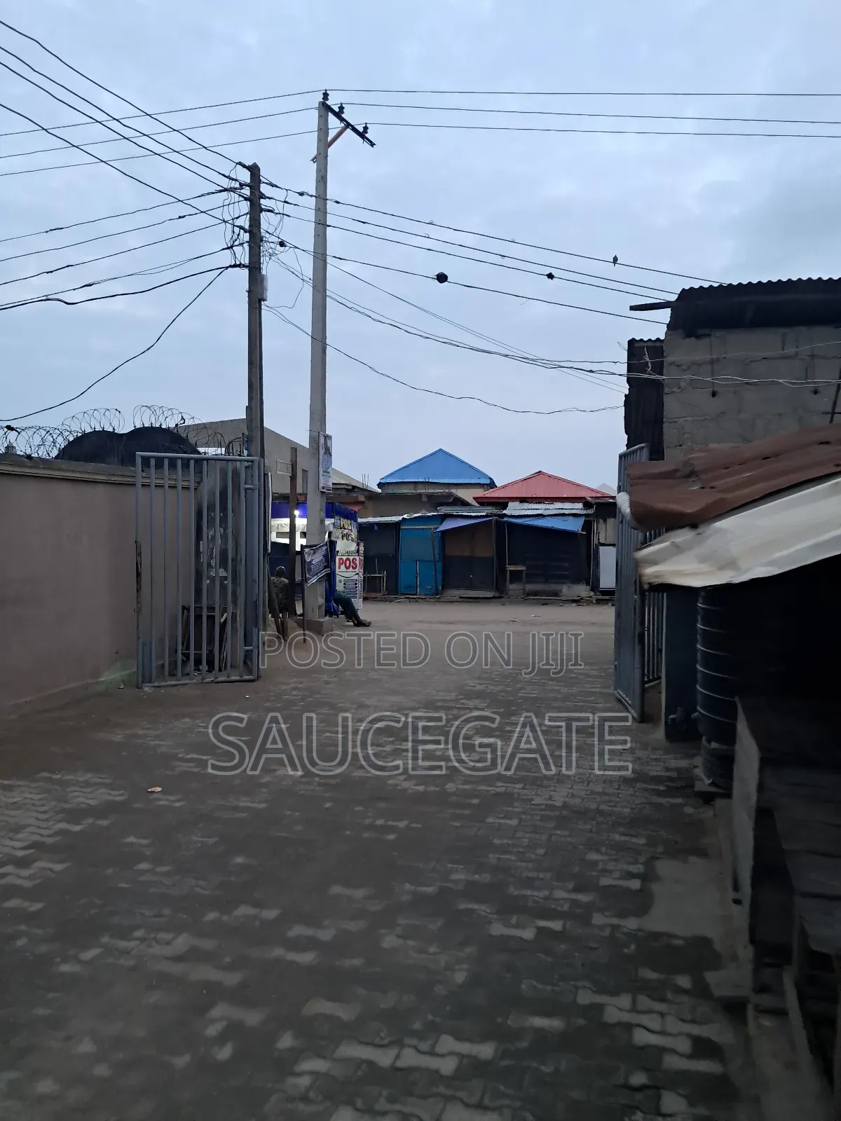 Land Facing a Busy Food Markert at Ijegun in Satellite Town