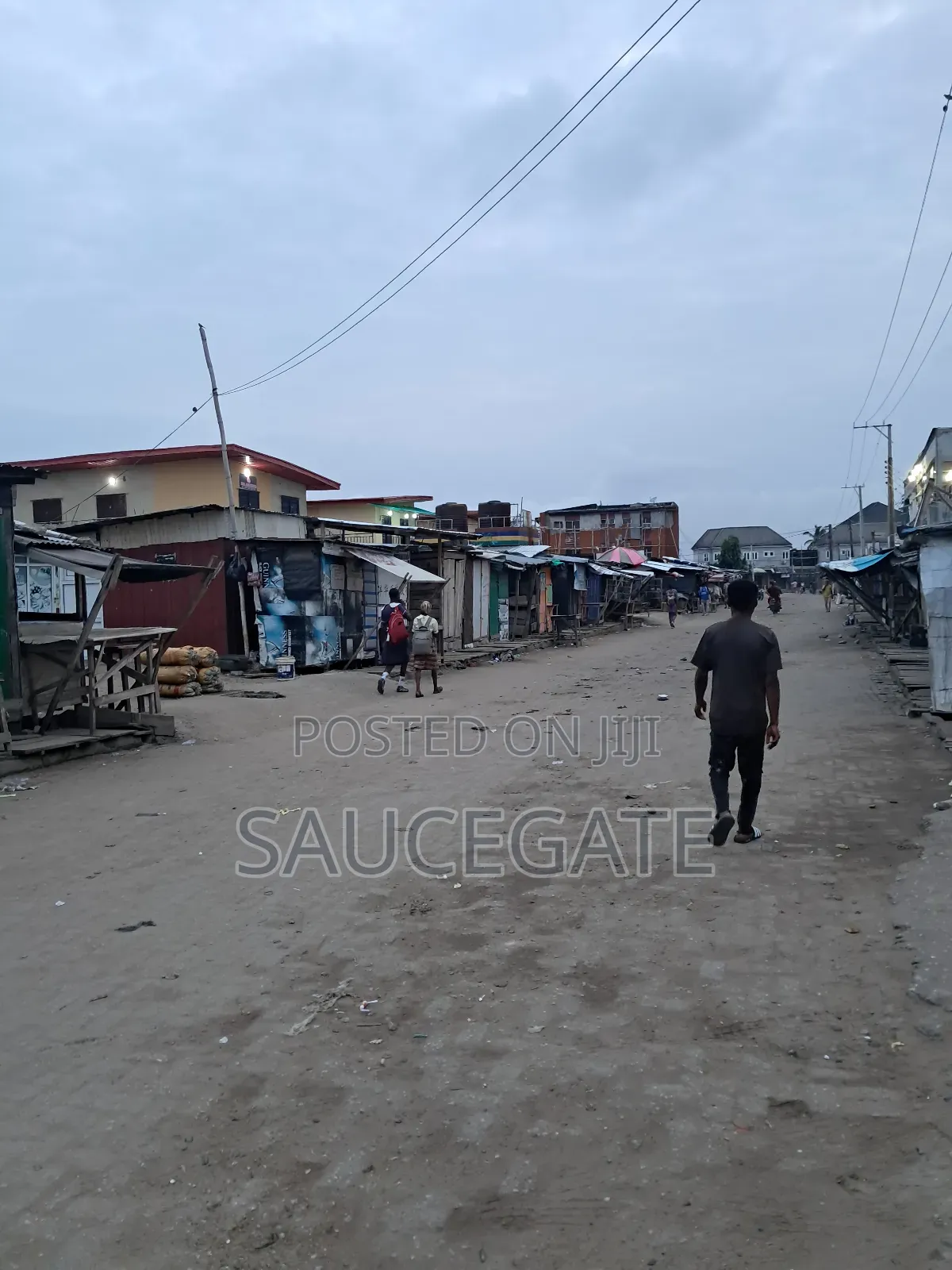 Land Facing a Busy Food Markert at Ijegun in Satellite Town