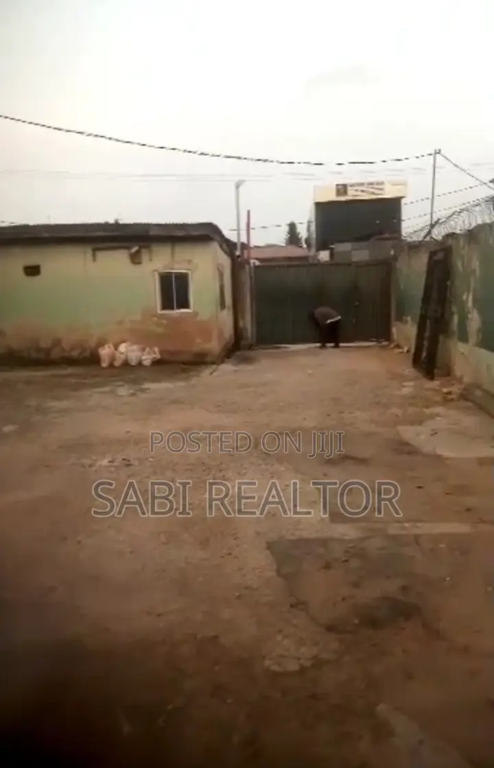 2 Plots of Land With Warehouse and 12 Shops Along a Major Road in Abule Egba
