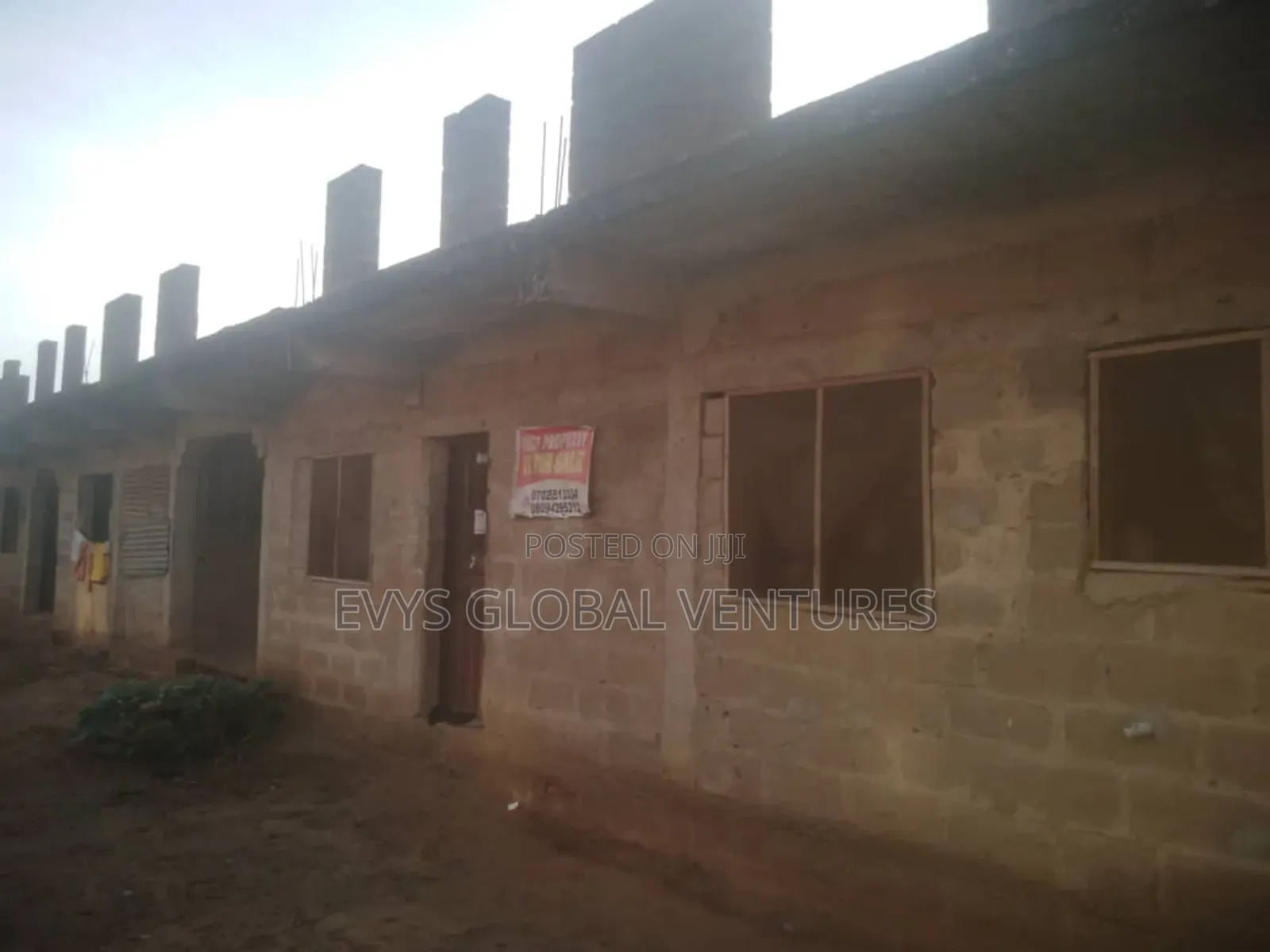 A 60 by 120 Full Plot of Land With a Building in Obafemi-Owode