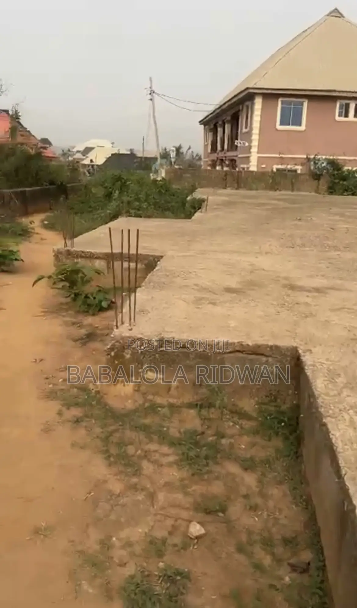 A Standard Full Plot of Land With German Floor in Akala Express