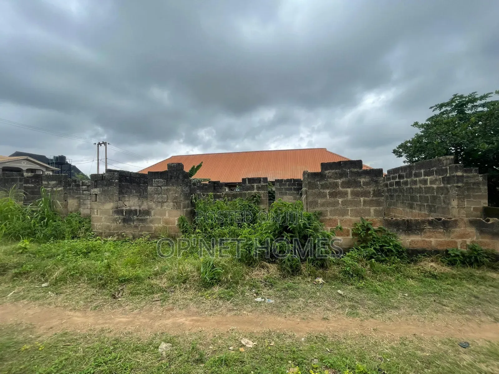A Plot of Land With an Uncompleted Building Facing a Major Road in Akure