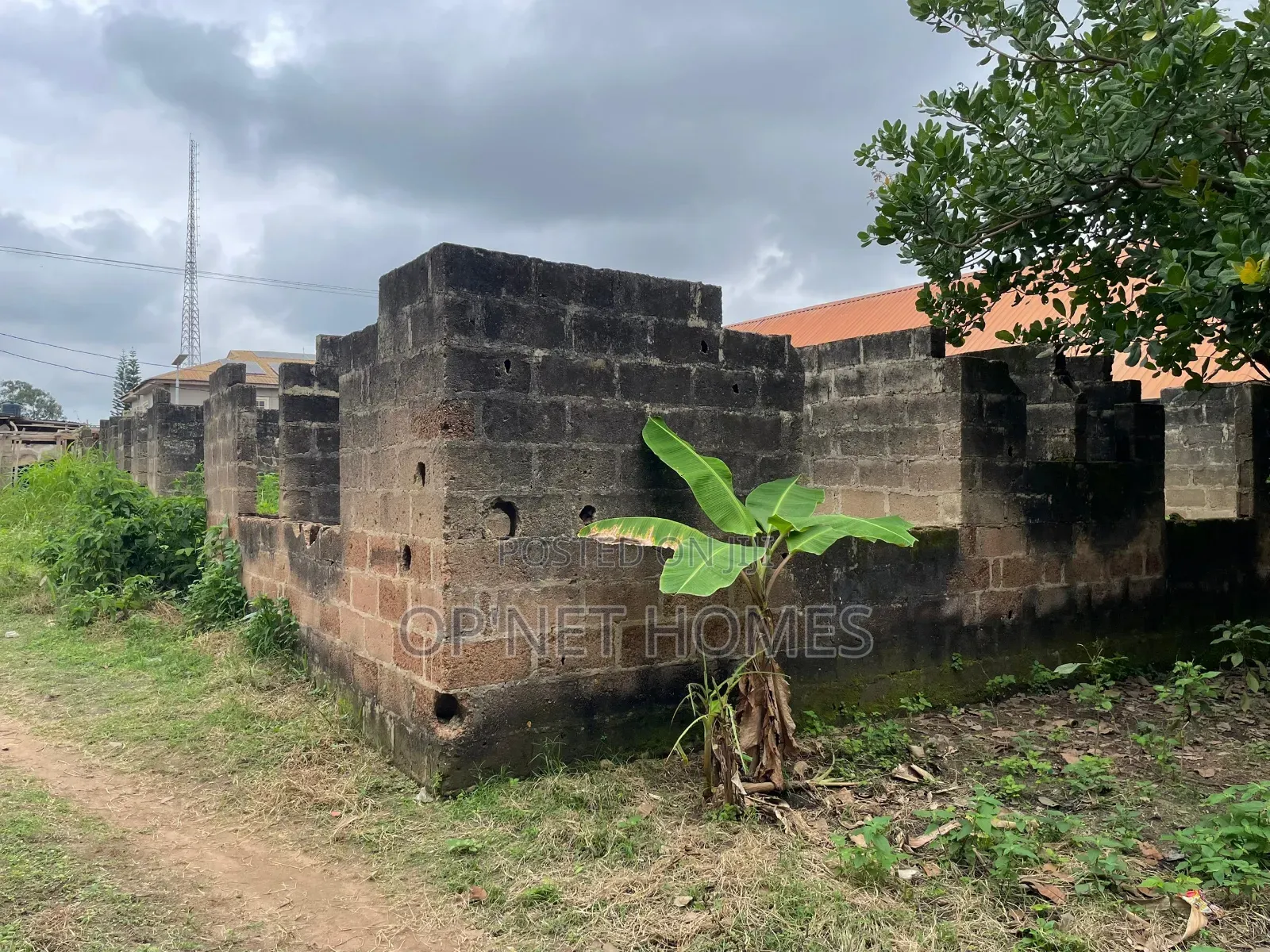 A Plot of Land With an Uncompleted Building Facing a Major Road in Akure