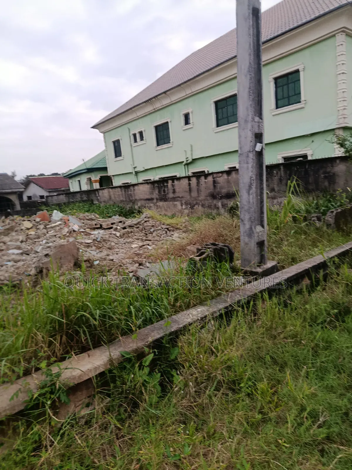 Dry half.plot of Land Fenced Round on a Corner Piece in Bucknor